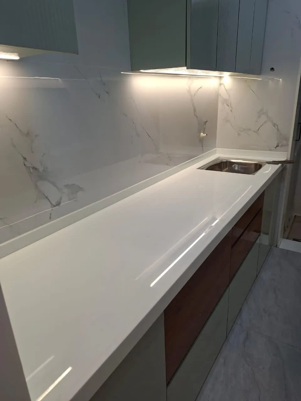 White kitchen platform with marble-look backsplash