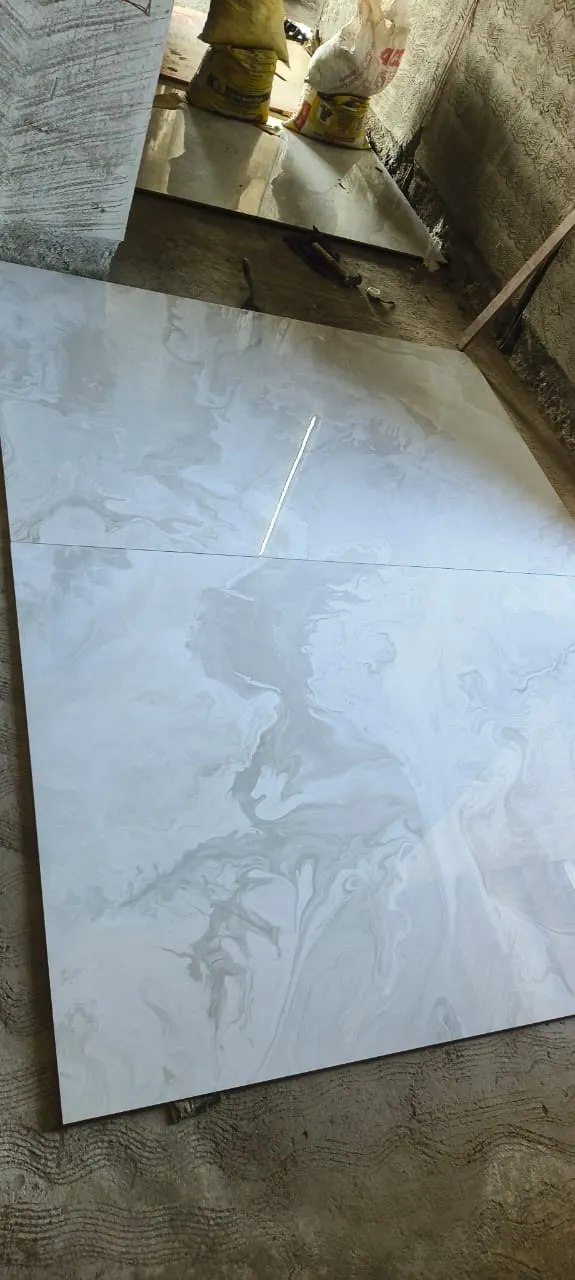 Large 600x1200 glossy vitrified floor tiles being laid